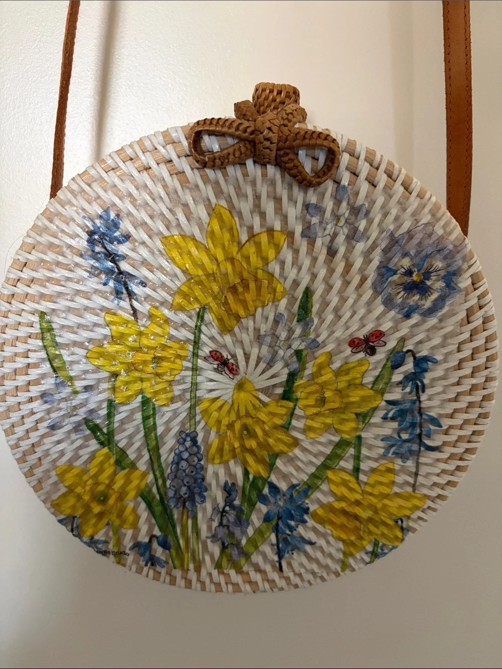 Round Straw Crossbody Bag with Yellow Floral Embroidery. 8x8 in., 24in strap